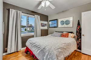 Bedroom with ceiling fan and wood finished floors