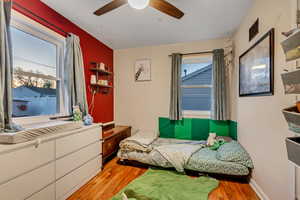 Bedroom with ceiling fan, visible vents, and light wood-style floors