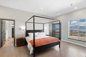 Bedroom with visible vents, light wood-type flooring, baseboards, access to outside, and recessed lighting