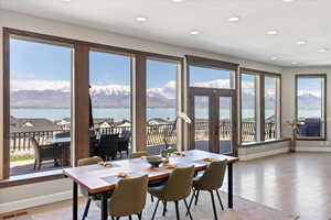 Dining space with a water view, baseboards, visible vents, and light wood-type flooring