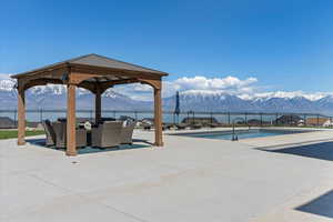 View of pool featuring a gazebo, a mountain view, fence, and a fenced in pool