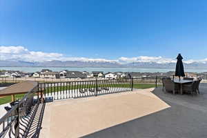 View of patio / terrace featuring a water and mountain view