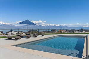 View of pool featuring a patio, fence, a mountain view, and a fenced in pool