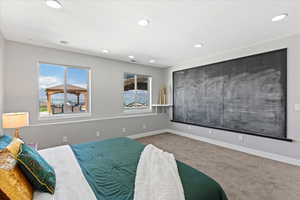 Carpeted bedroom with recessed lighting and baseboards
