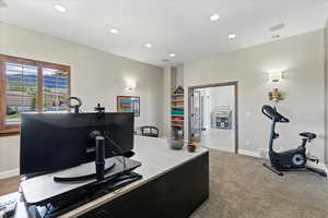 Carpeted office with recessed lighting and baseboards