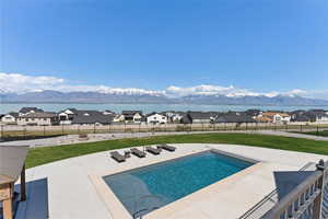 View of swimming pool with a fenced backyard, a fenced in pool, a yard, and a patio area