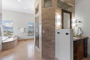 Full bath with a bath, tile patterned flooring, a shower stall, vanity, and a water view