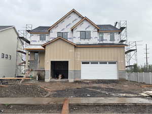 Property in mid-construction with a chimney, driveway, a garage, and fence
