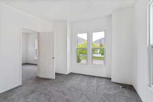 Unfurnished room with visible vents and carpet