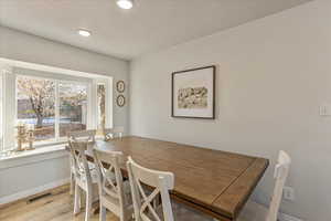 Dining space with baseboards, recessed lighting, light wood-style flooring, and visible vents