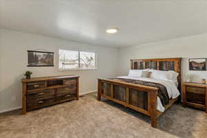 Carpeted bedroom with baseboards