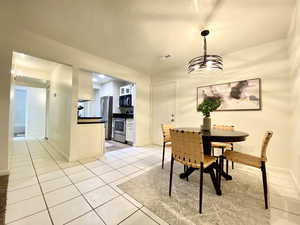 Dining space featuring baseboards, visible vents, and light tile patterned floors