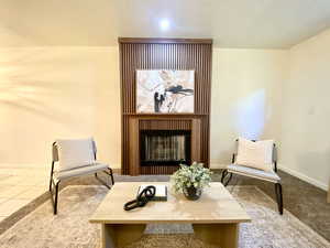 Sitting room with baseboards and a fireplace