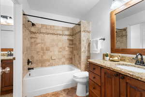 Full bathroom featuring vanity, toilet, and bathtub / shower combination