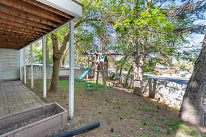 View of yard featuring a playground and fence private yard