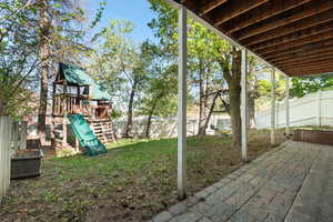 Exterior space featuring a fenced backyard and a playground