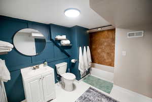Bathroom featuring vanity, baseboards, toilet, and visible vents