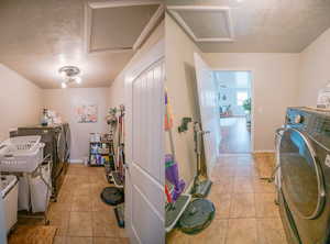 Laundry room with laundry area, washing machine and dryer, light tile patterned floors, and attic access