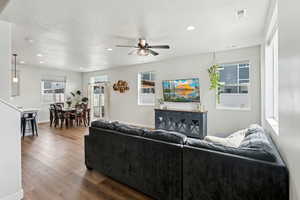 Living room with a ceiling fan, a textured ceiling, visible vents, dark wood finished floors, and recessed lighting