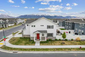 View of front of house featuring a mountain view, stone siding, and a residential view