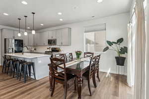 Dining area with light wood-style floors, recessed lighting, baseboards, and visible vents