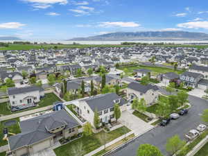 Birds eye view of property featuring a water and mountain view and a residential view