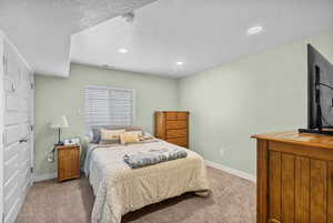 Bedroom with visible vents, recessed lighting, baseboards, and light carpet