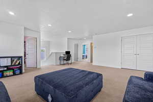 Carpeted bedroom featuring recessed lighting and a textured ceiling