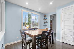 Dining area featuring recessed lighting, a textured ceiling, dark wood finished floors, and baseboards
