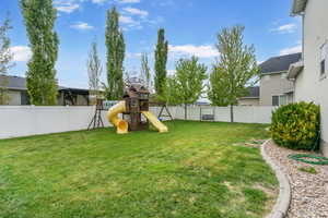 View of yard featuring a fenced backyard and a playground