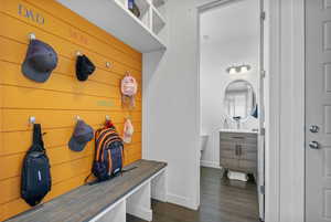 Mudroom featuring baseboards and dark wood-style flooring