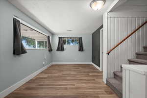 Stairs with baseboards and wood finished floors