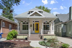Bungalow featuring covered porch and a shingled roof