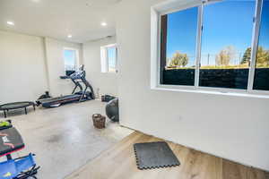 Exercise area with recessed lighting and wood finished floors