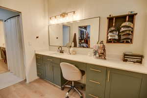 Full bathroom with vanity and wood finished floors