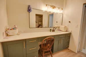 Bathroom featuring wood finished floors and vanity