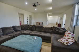 Living room featuring recessed lighting, light wood-style flooring, and visible vents
