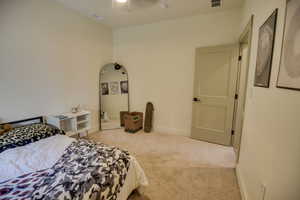 Bedroom with carpet floors, baseboards, visible vents, and ceiling fan