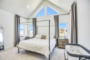 Carpeted bedroom with baseboards, recessed lighting, and high vaulted ceiling