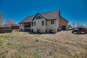 Back of property with roof with shingles, fence, and a balcony