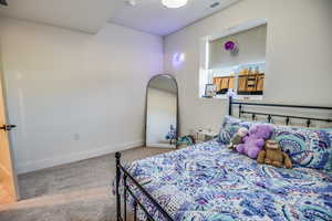 Bedroom with baseboards, carpet, and visible vents