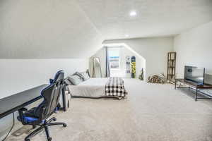 Carpeted bedroom with recessed lighting, a textured ceiling, and vaulted ceiling