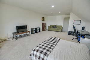 Carpeted bedroom with recessed lighting