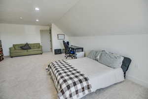 Carpeted bedroom with recessed lighting, a textured ceiling, and lofted ceiling