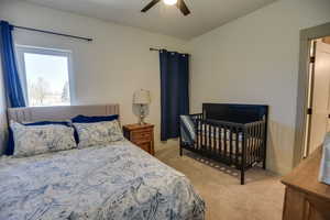 Bedroom featuring ceiling fan and light carpet