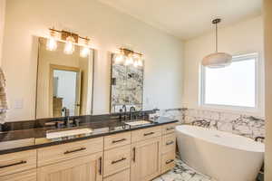Full bathroom with double vanity, a sink, and marble finish floor