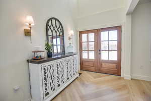 Foyer with baseboards and french doors