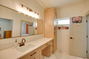 Bathroom with marble finish floor and vanity