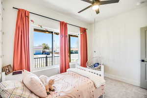 Bedroom with carpet floors, baseboards, and ceiling fan