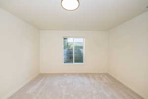 Empty room with baseboards, light carpet, and visible vents
